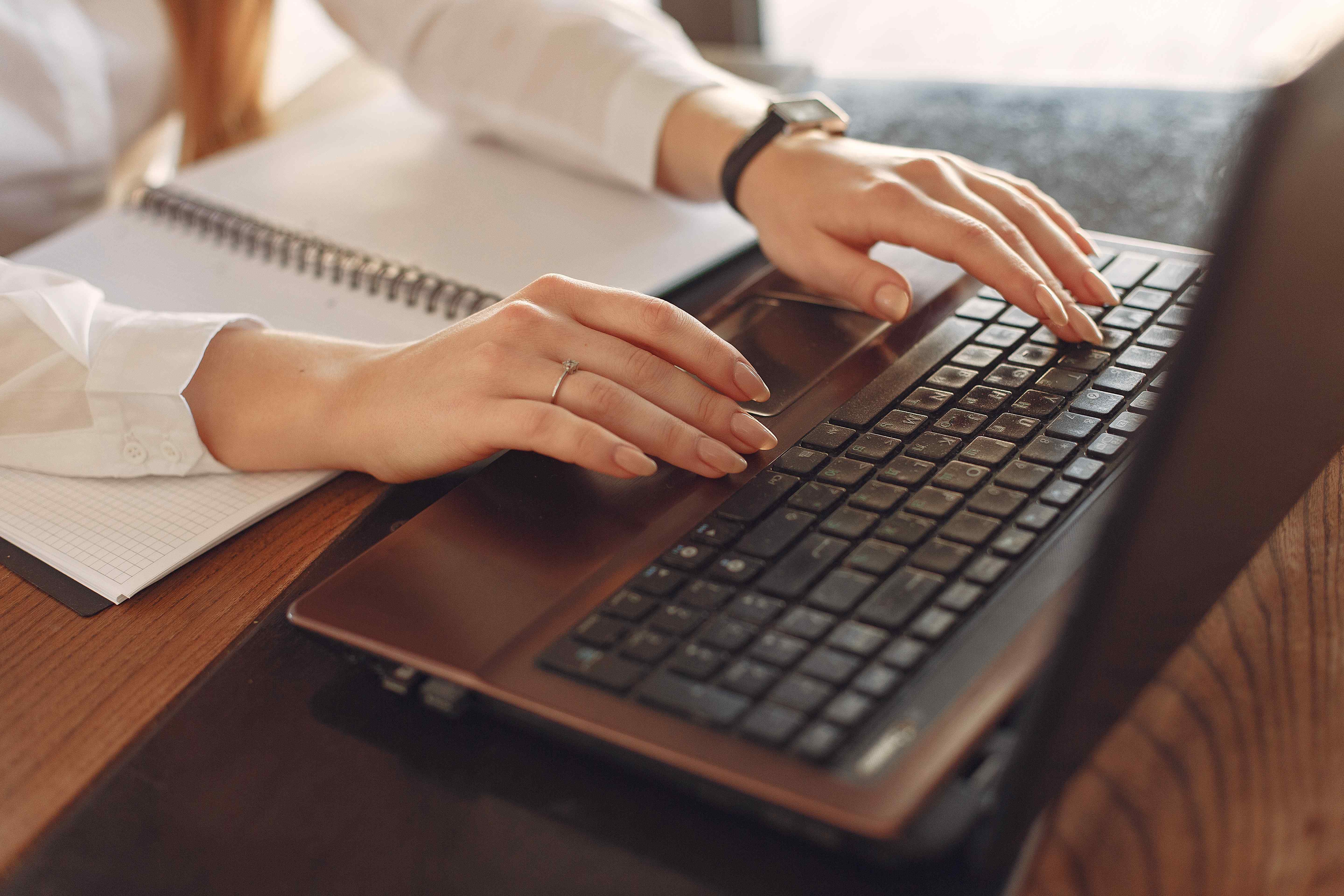Woman typing on her laptop