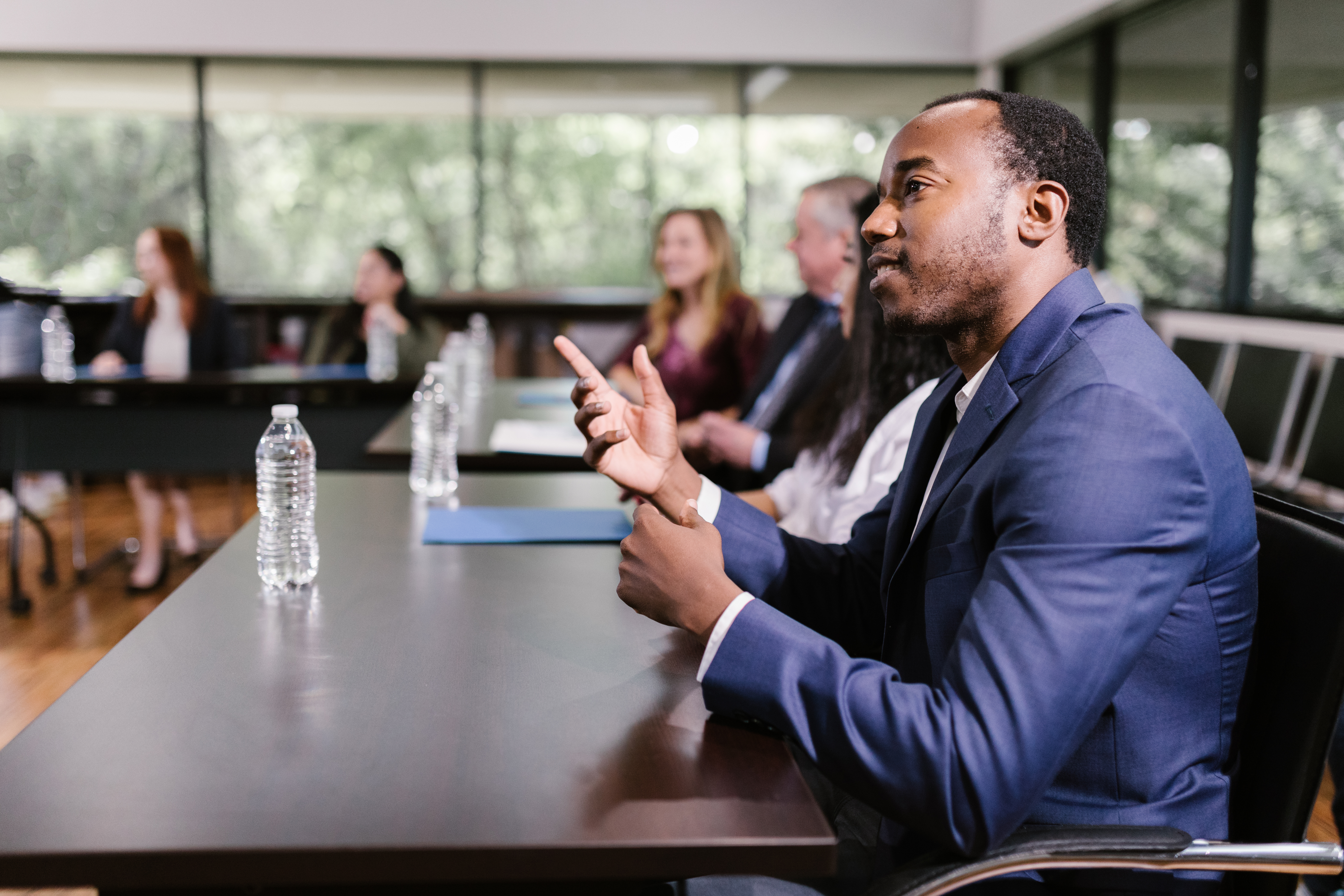 Man wearing a blue suit in a meeting