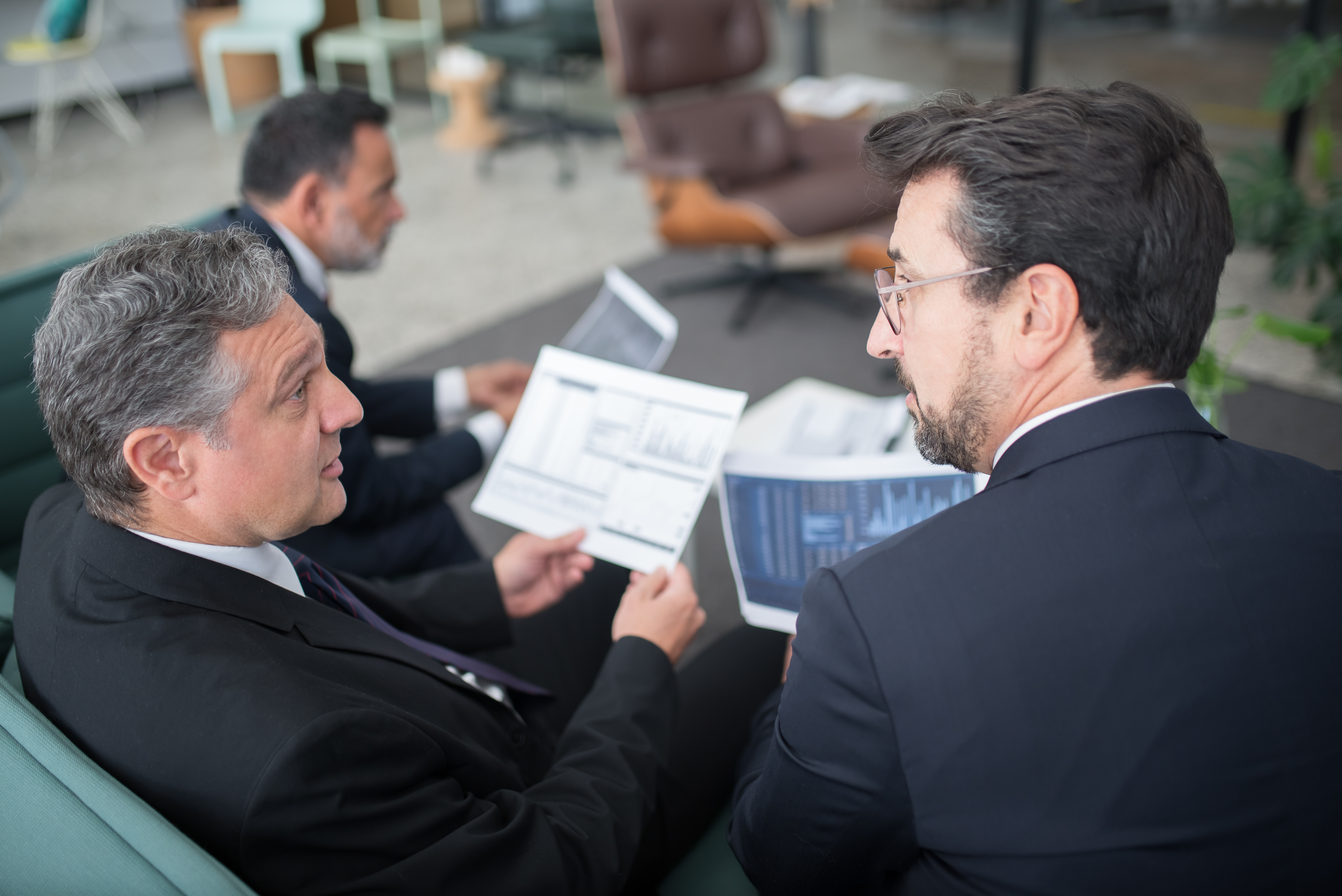 Men in suits discussing business